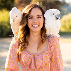 Maya Higa with two cockatoos on her shoulders